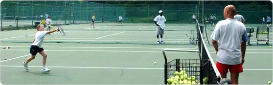 Child practicing tennis