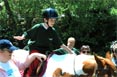 A boy enjoys his therapeutic horseback ride. A boy enjoys his therapeutic horseback ride.
