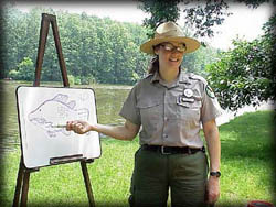 Photo of Ranger teaching by river