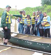 Photo of Ranger and kids with canoe