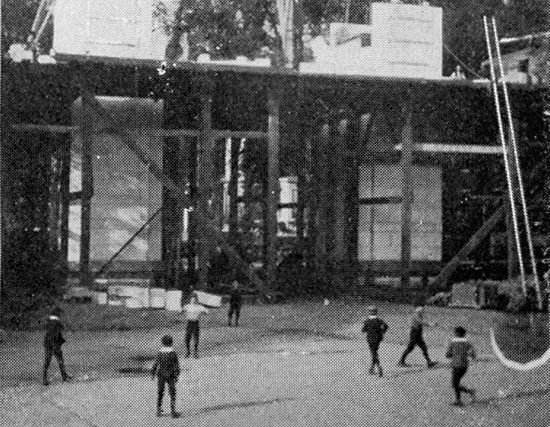 Image of  Boys play baseball in the shadow of the Washington Square Arch as it is constructed, circa 1890-92.