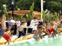 Image of children jumping into the water with Commissioner Benepe at Citywide Pool Opening Astoria Pool Queens links to the photojournal for 5/10/04 to 6/25/04