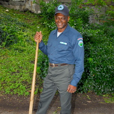 Parks Employee raking grass in a park