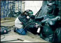 Photo of conservator working on a sculpture