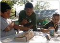 Parks staff members painting with a child