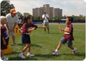 Boy passing a baton to a girl