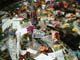 Image of Candles, flowers and Beatles mementos cover the Imagine monument the day after George Harrison�s death.  Photo by S.T. Tucker