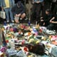 Image of Mourners leave gifts at the Imagine mosaic in honor of George Harrison on November 30, 2001, the day after his death. Photo by S.T. Tucker