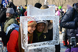 two people posing in an ice carved frame