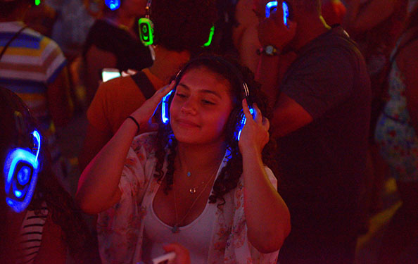 a girl dances while listening to music on headphones