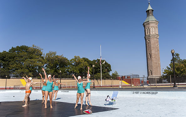 dancers perform in a drained-out pool