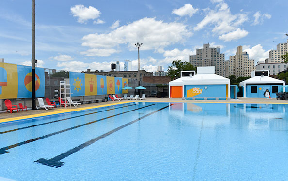 View from the deck of lounge chairs and brightly-painted walls at Douglas and Degraw Pool
