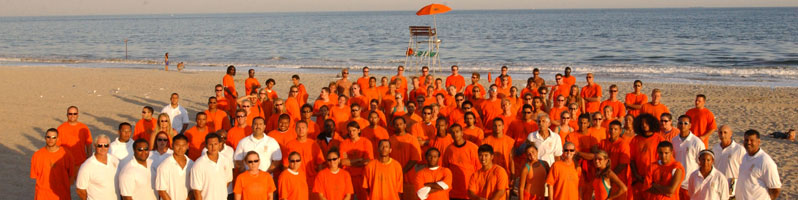 group of lifeguards posing on a beach